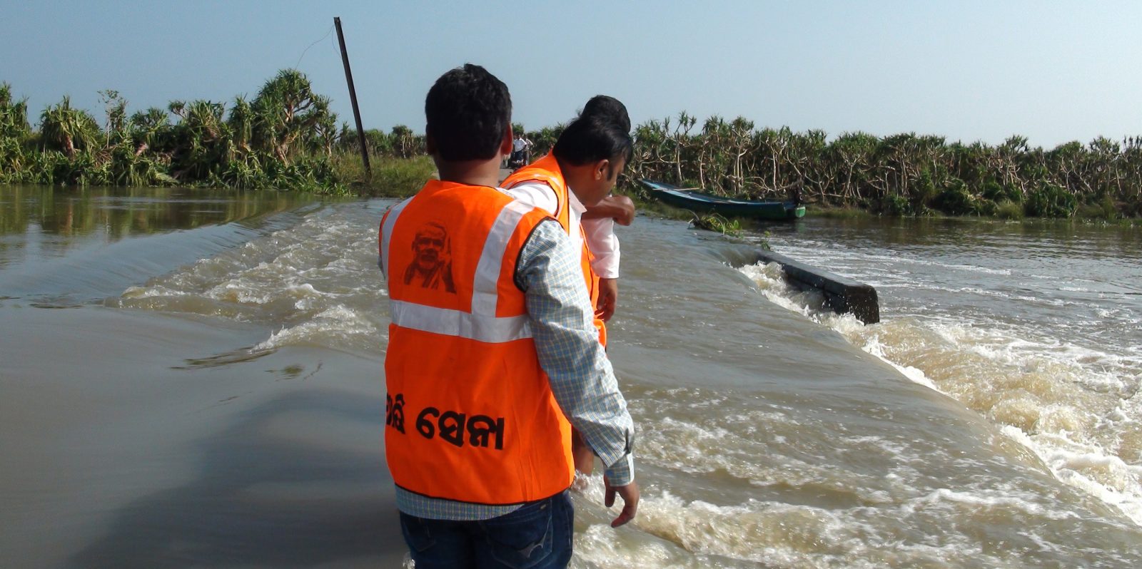 Murali Sharma crosses rivulet to reach marooned Markundi (Worst hit village in Odisha by Phailin) in Ganjam