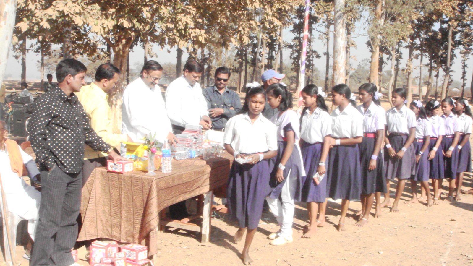 Murli distributes books among students in his district